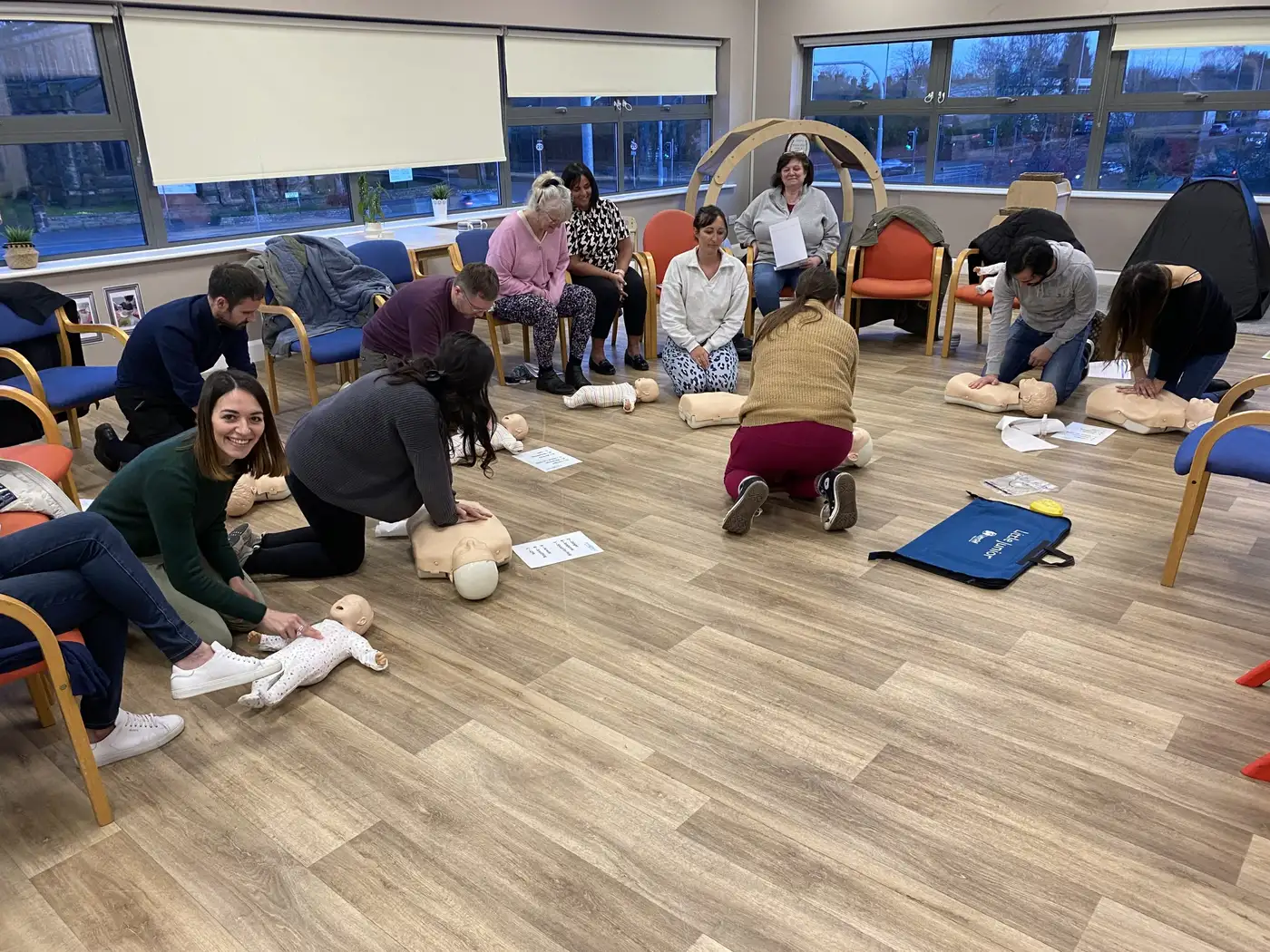Parents practising baby CPR on first aid course Parents practising baby CPR on first aid course